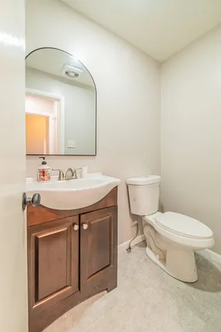 a bathroom with a sink toilet and mirror