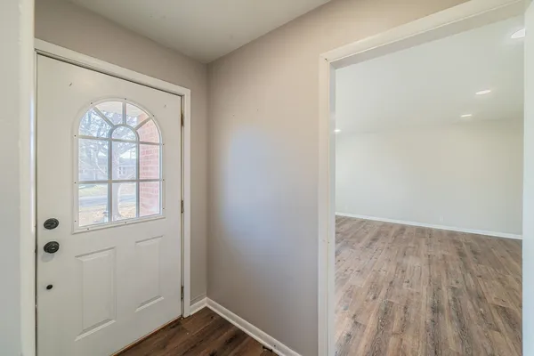 wooden floor in an empty room with a window