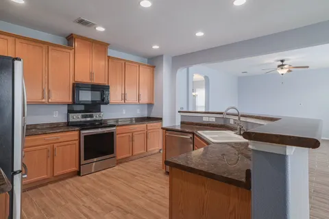 a kitchen with a refrigerator and a stove top oven