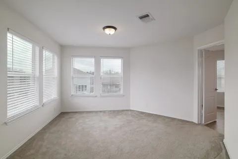 a spacious bathroom with a double vanity sink and a mirror