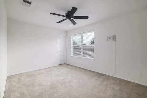a bathroom with a sink a toilet and a large mirror