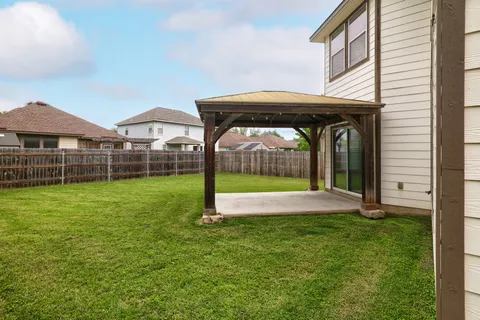 a view of an house with backyard porch and furniture
