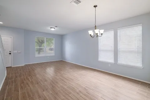 a view of a room with wooden floor and windows