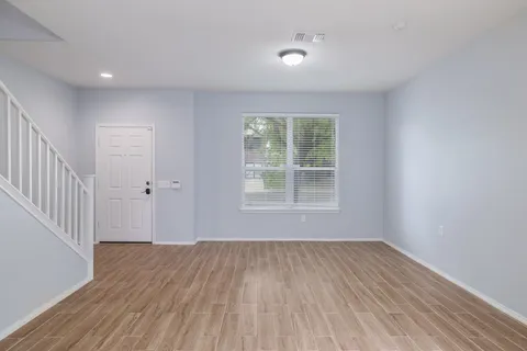wooden floor in an empty room with a window