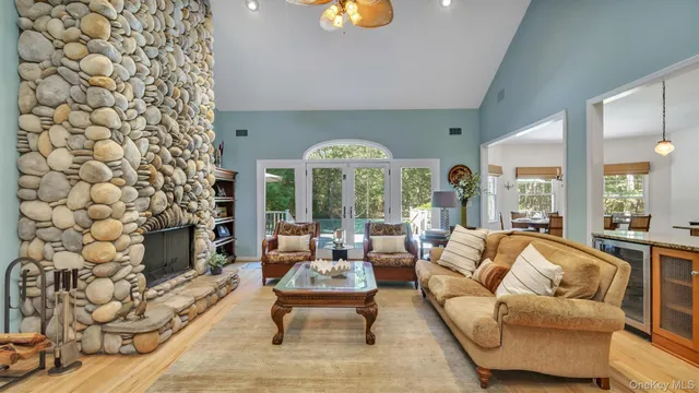 a living room with furniture a fireplace and a chandelier