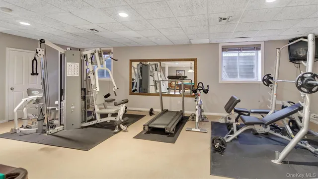 a living room with furniture a flat screen tv and a table