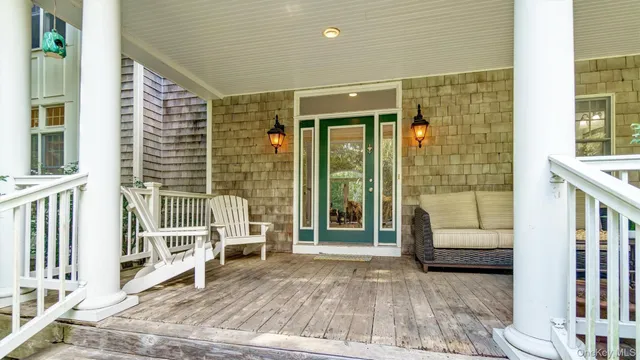 a living room with fireplace furniture and floor to ceiling windows
