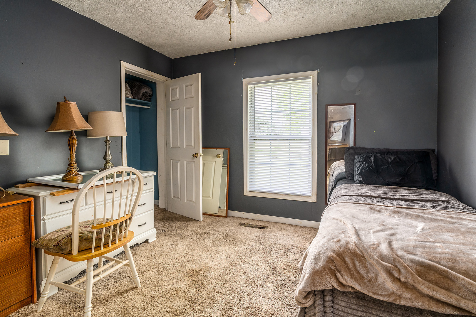 202 South Ervin Street Pittsburg, IL 62974 - Photo 16 of 42 a bedroom with a bed a chair and potted plant on the dresser