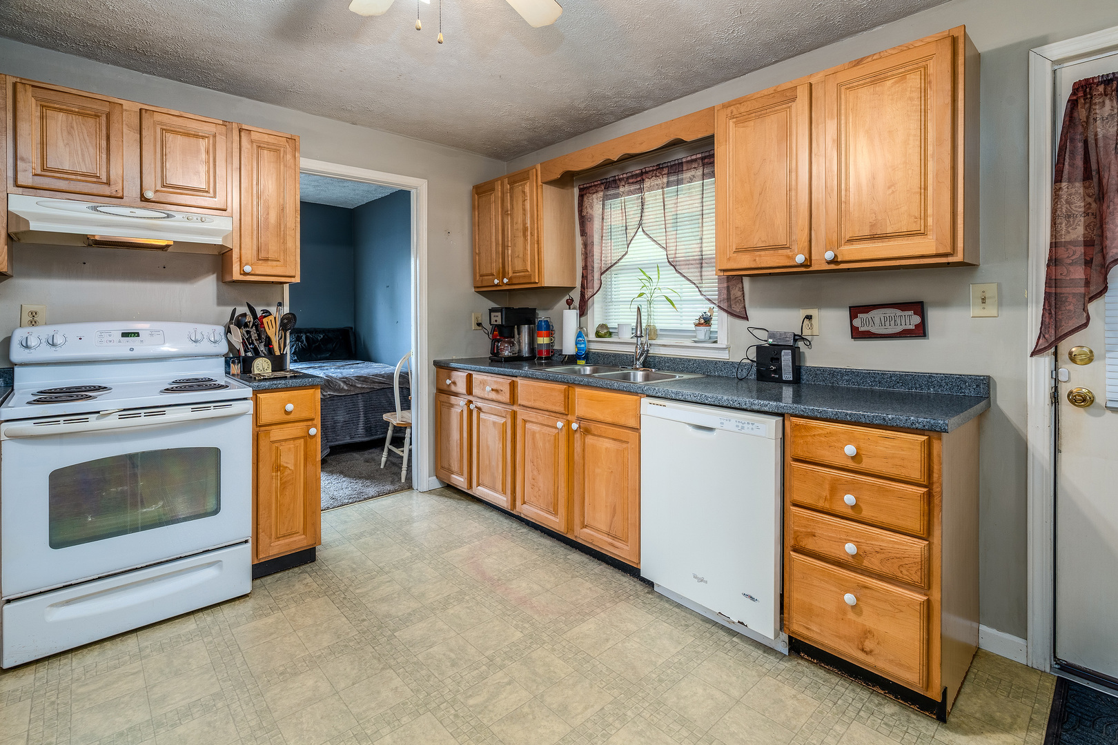 202 South Ervin Street Pittsburg, IL 62974 - Photo 10 of 42 a kitchen with stainless steel appliances granite countertop a stove sink and cabinets