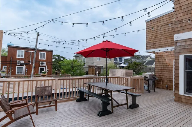 a view of a house with pool and chairs