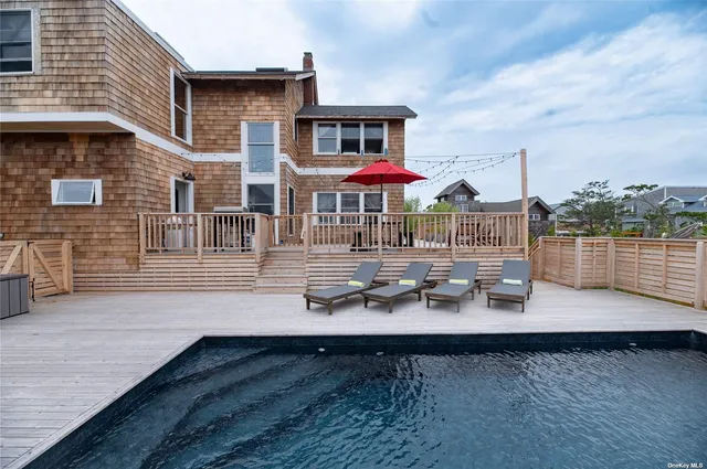 a balcony with furniture and umbrella