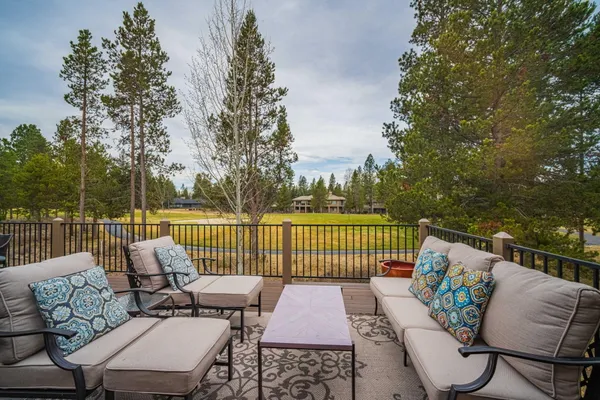 a roof deck with couches and wooden floor