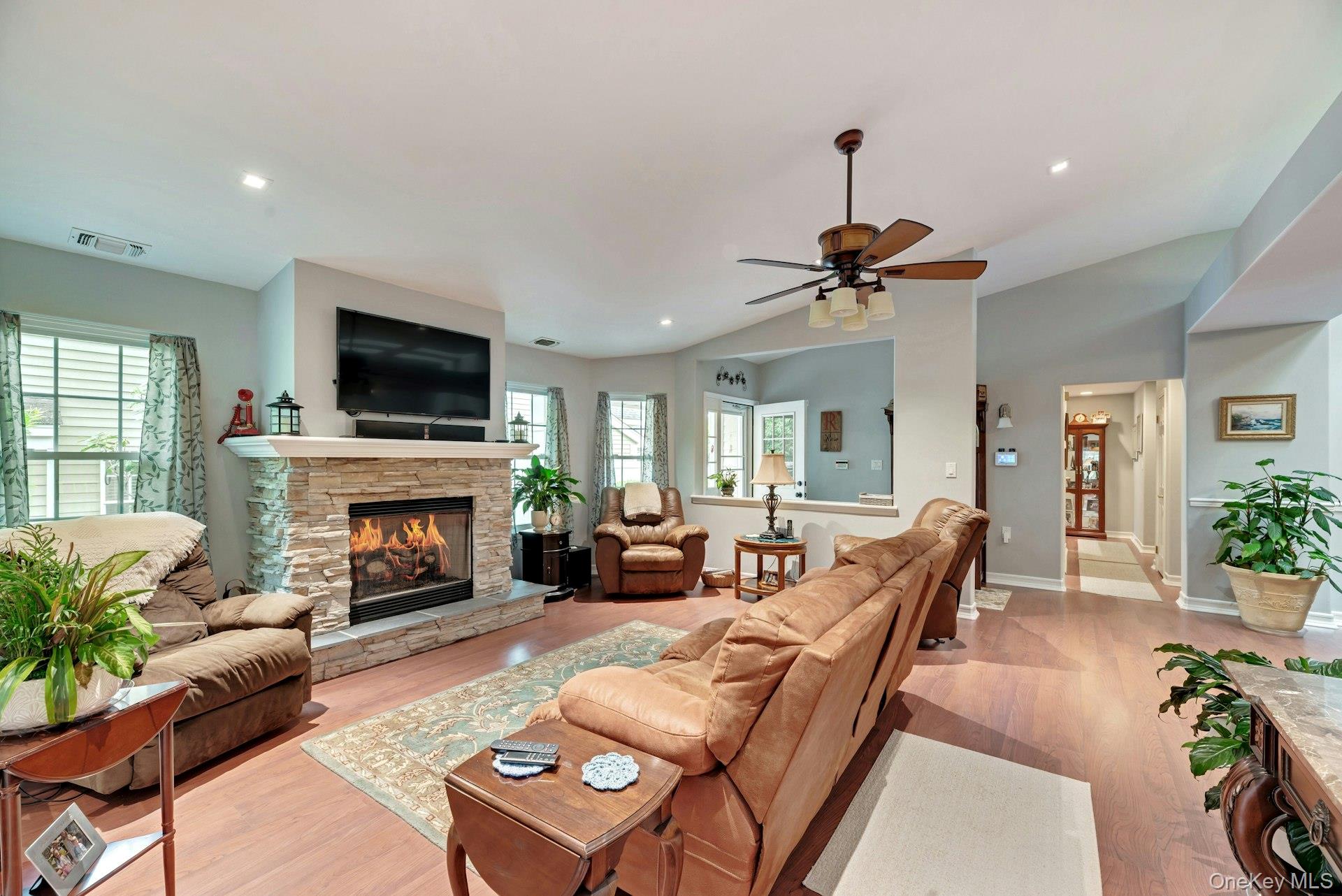 104 Glen Drive Ridge, NY 11961 - Photo 7 of 25 a living room with furniture a fireplace and a flat screen tv