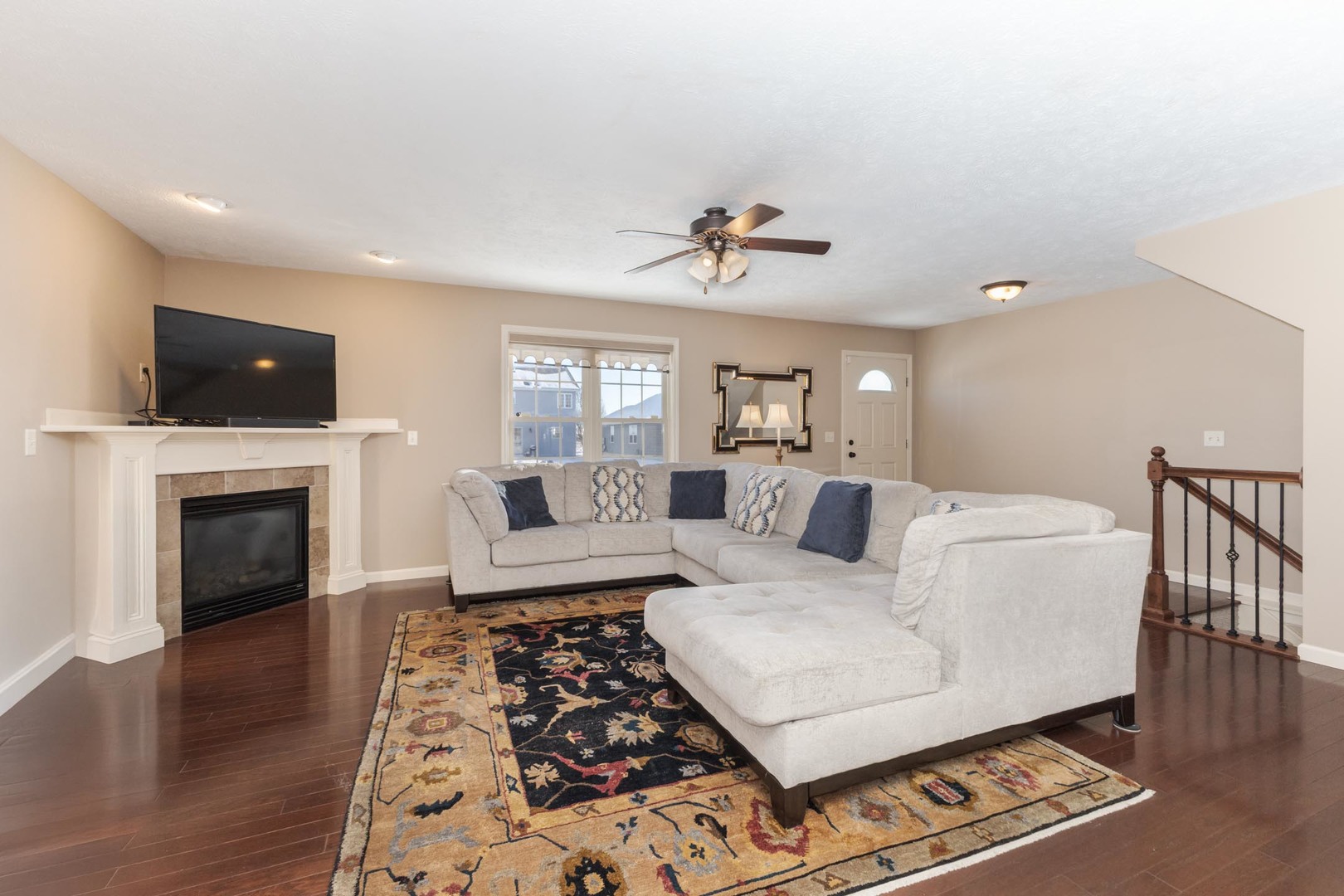 1646 Belclare Road Normal, IL 61761 - Photo 16 of 50 a living room with furniture a fireplace and a flat screen tv