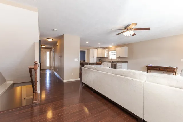 a living room with furniture and kitchen view