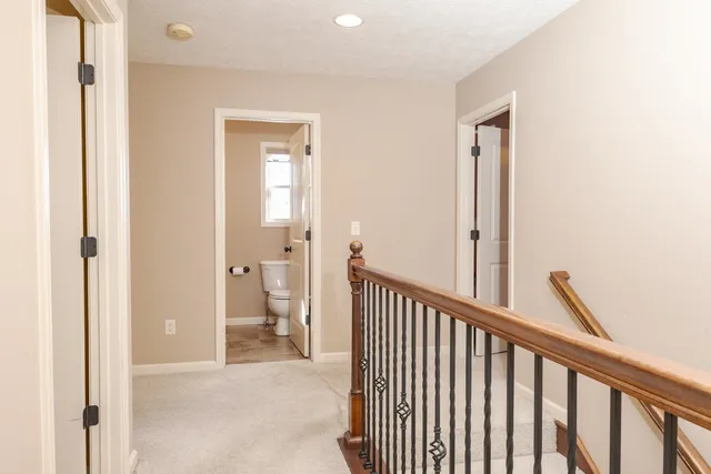 a view of a hallway with an entryway and livingroom