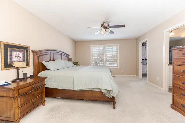 a spacious bedroom with a bed and a window