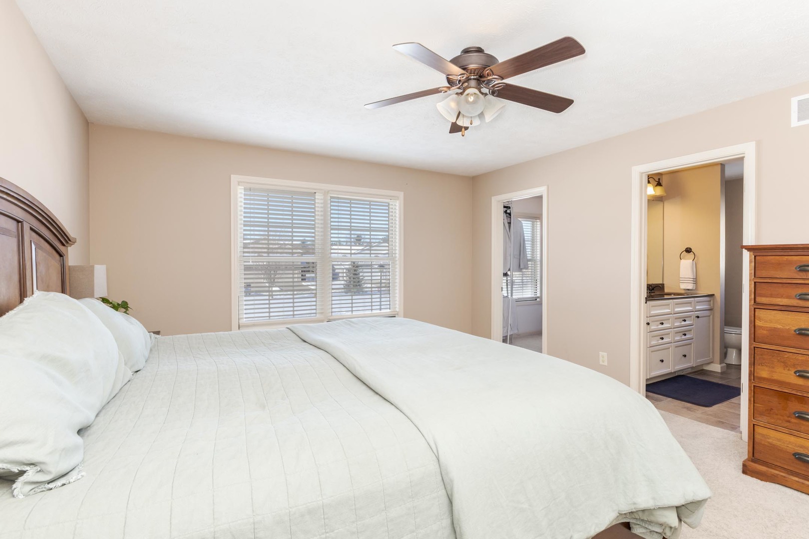 1646 Belclare Road Normal, IL 61761 - Photo 27 of 50 a bedroom with a large bed and a chandelier