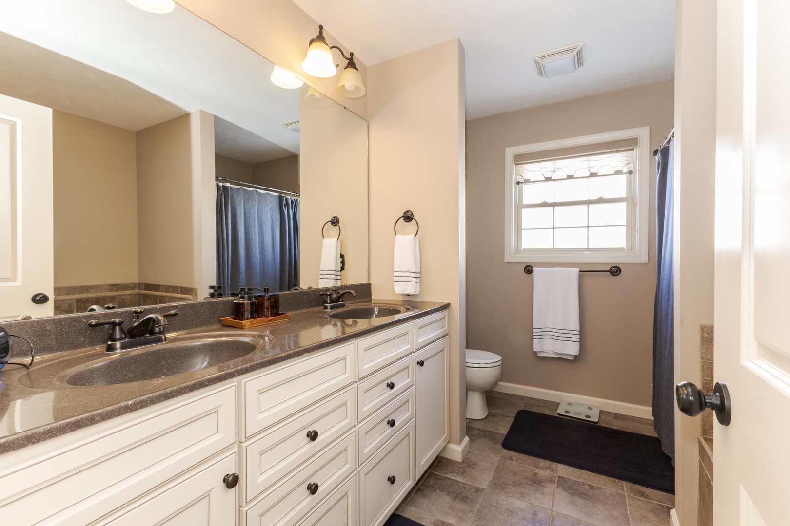 1646 Belclare Road Normal, IL 61761 - Photo 28 of 50 a bathroom with a double vanity sink toilet mirror and bathtub