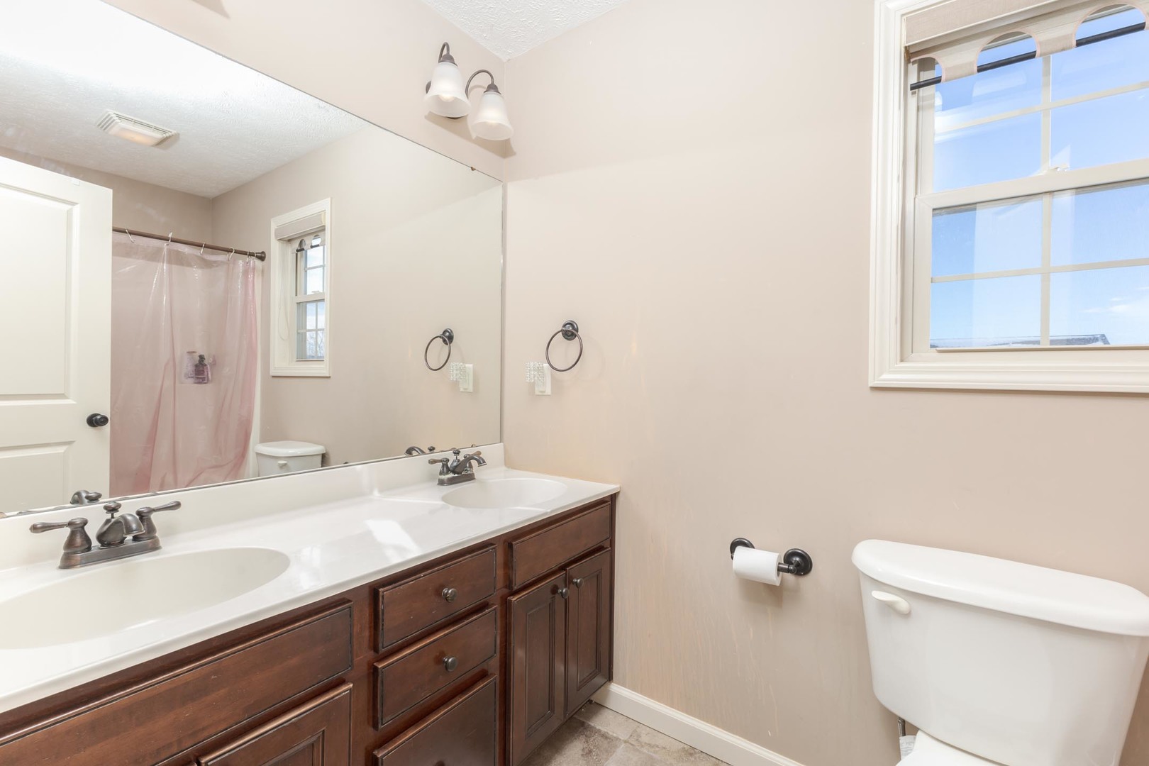 1646 Belclare Road Normal, IL 61761 - Photo 32 of 50 a bathroom with a double vanity sink toilet and a mirror