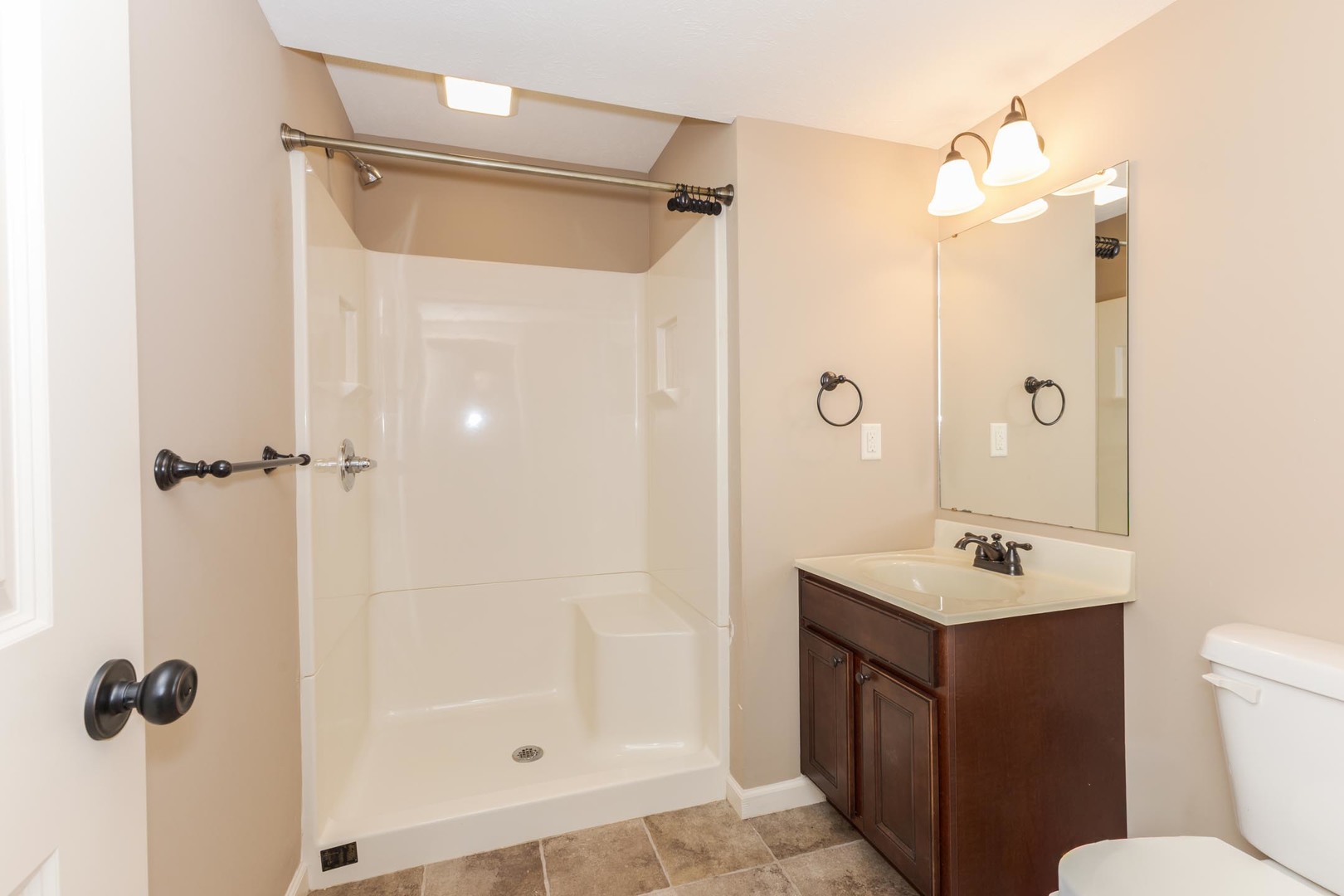 1646 Belclare Road Normal, IL 61761 - Photo 39 of 50 a bathroom with a shower sink vanity and mirror