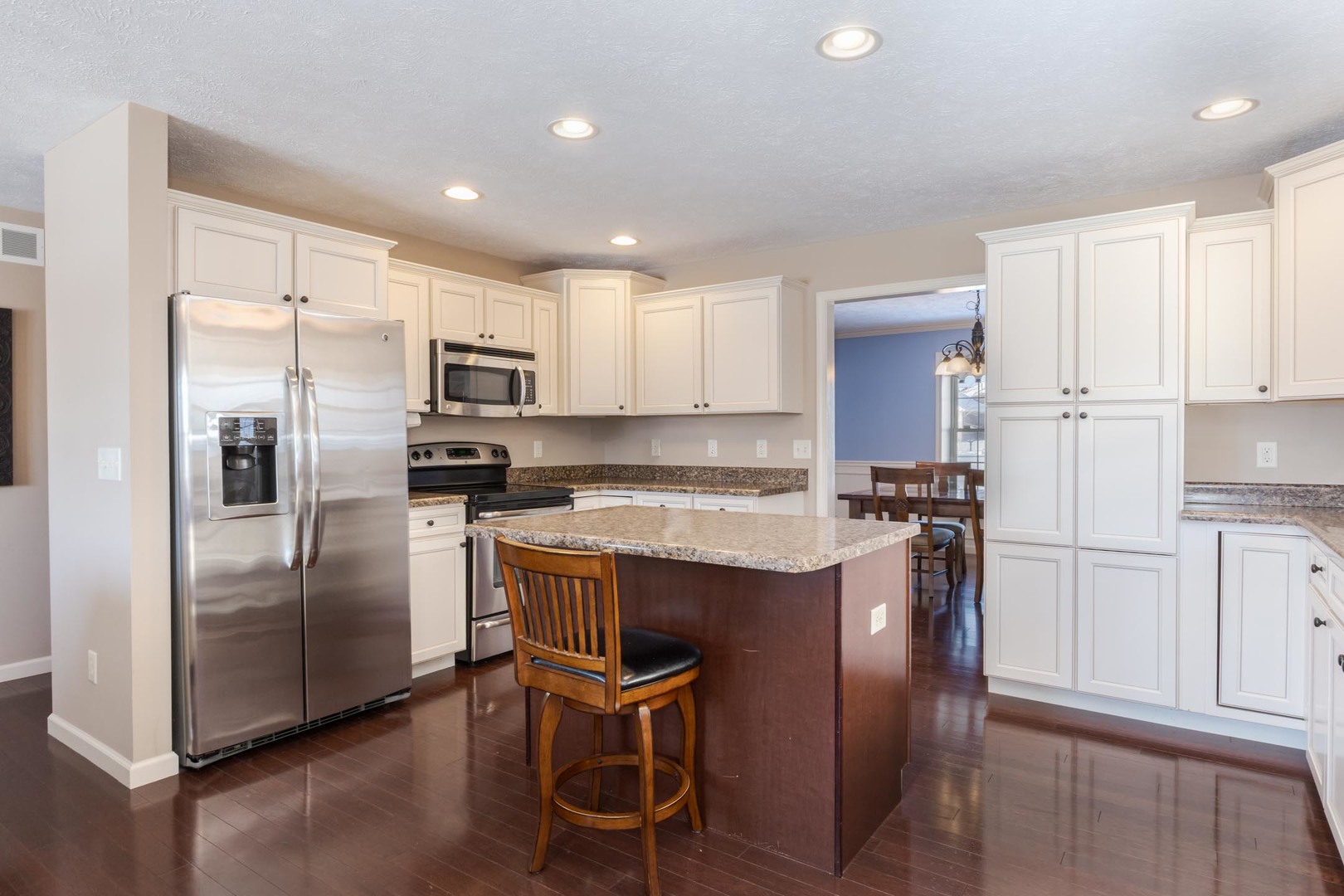 1646 Belclare Road Normal, IL 61761 - Photo 9 of 50 a kitchen with kitchen island a refrigerator stove microwave and cabinets