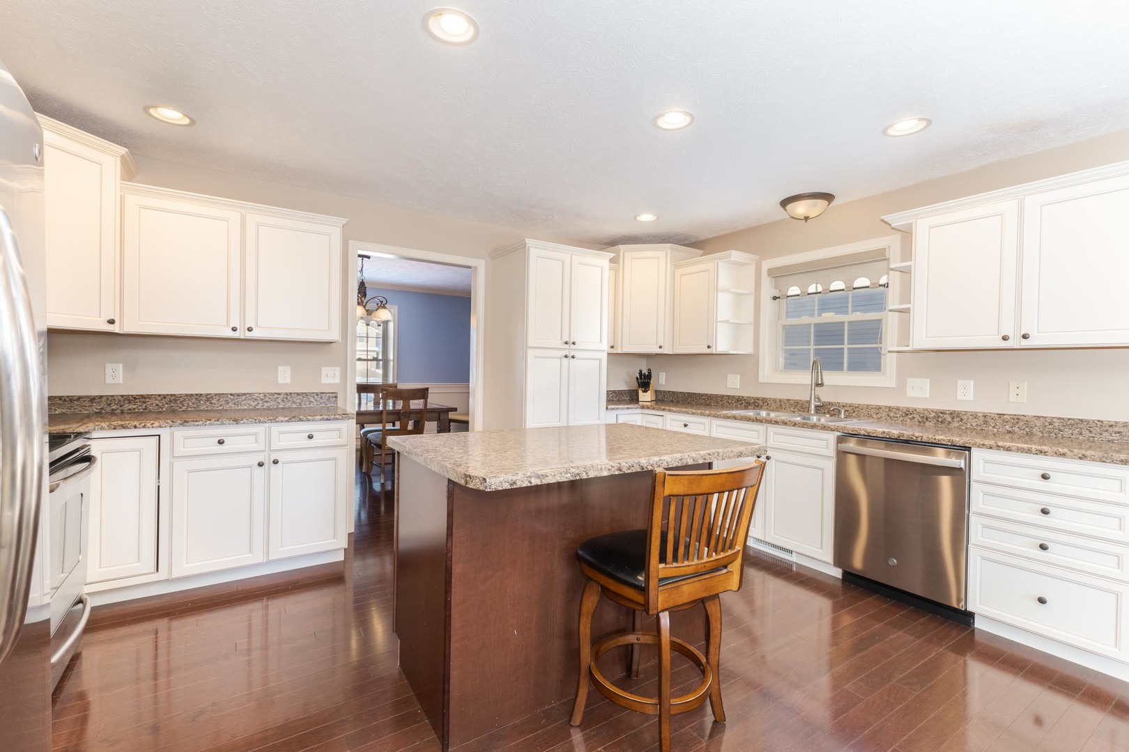 1646 Belclare Road Normal, IL 61761 - Photo 10 of 50 a kitchen with granite countertop white cabinets and white appliances
