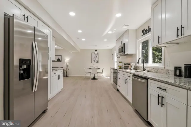 a large kitchen with stainless steel appliances kitchen island granite countertop a large counter top stainless steel appliances and cabinets