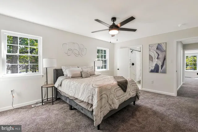 a spacious bedroom with a bed and a window