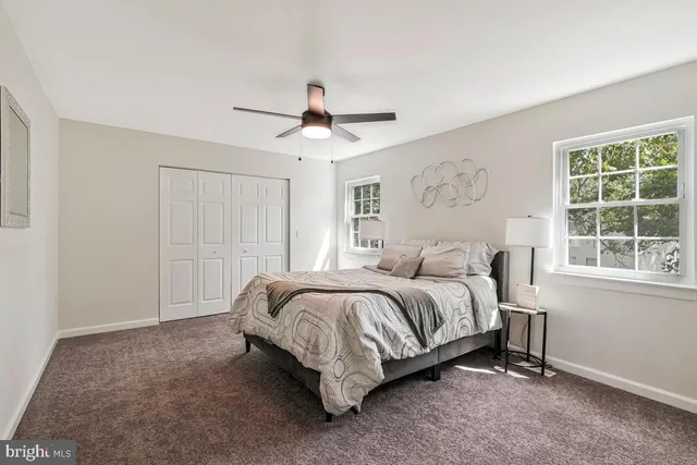 a spacious bedroom with a bed and a window