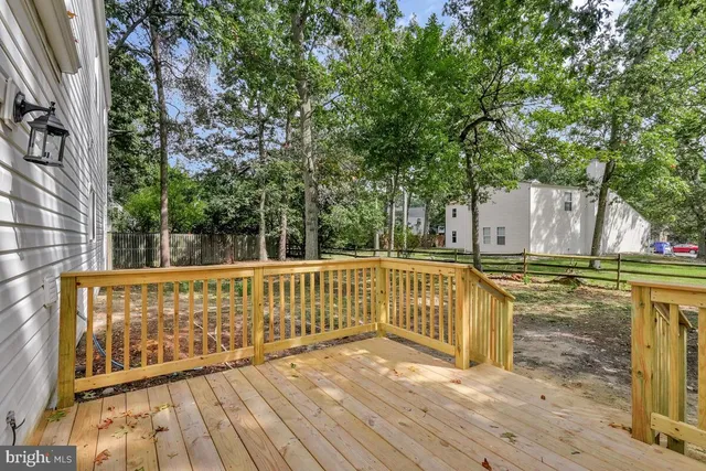 a view of balcony with wooden floor and fence