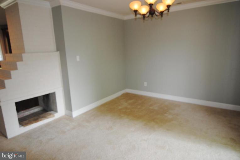 5818 Atteentee Road Springfield, VA 22150 - Photo 15 of 22 Dining room w/two-sided fireplace & crown molding.