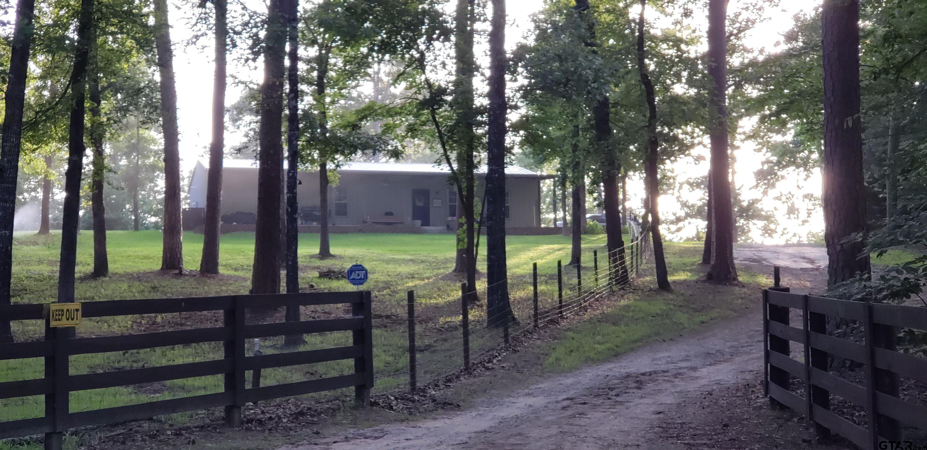14032 Eastside Road Tyler, TX 75707 - Photo 15 of 36 a view of a park with large trees and a swing