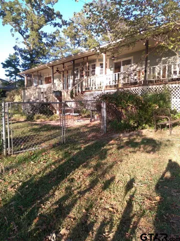 a view of a big yard with large trees