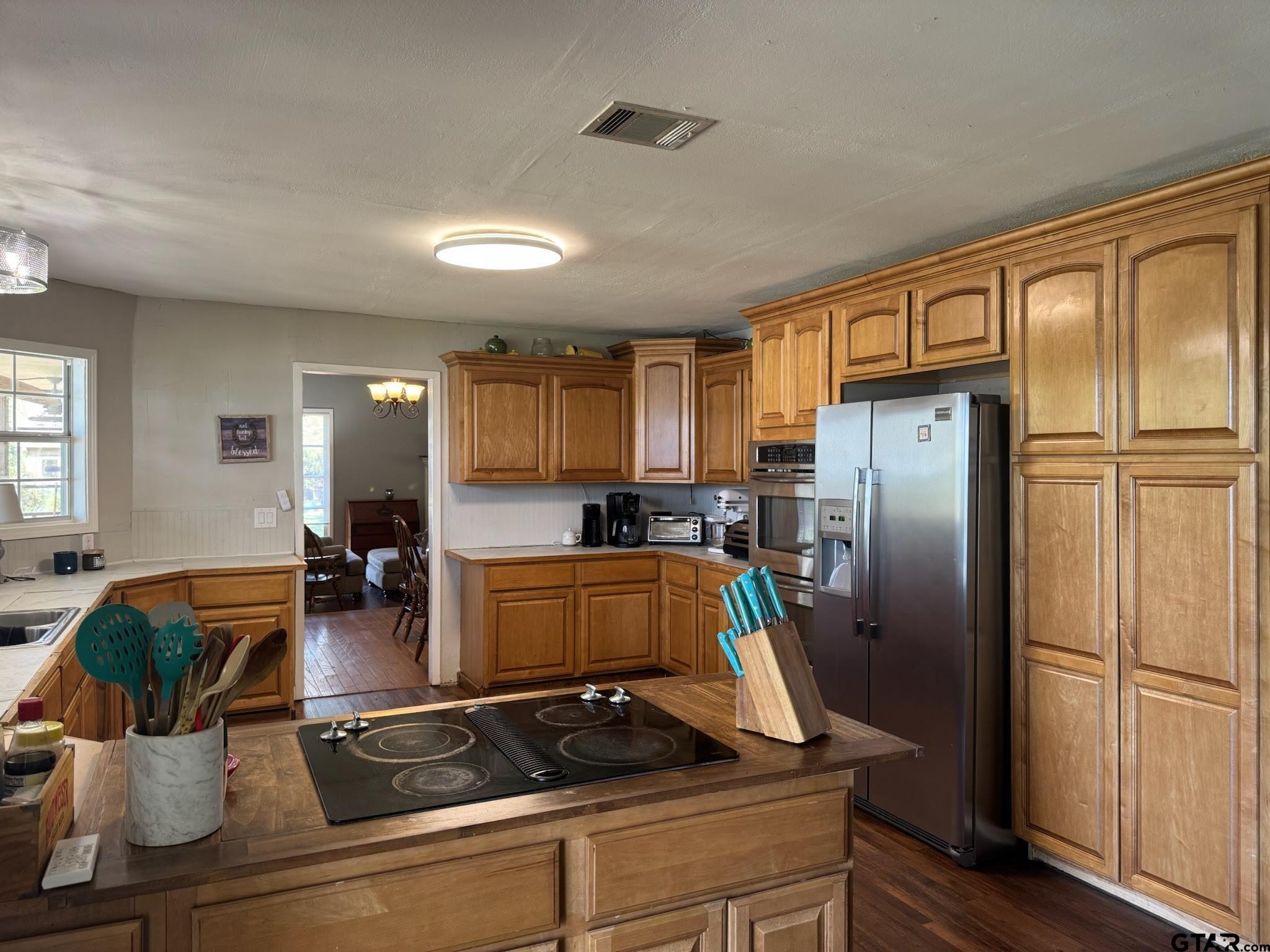 14032 Eastside Road Tyler, TX 75707 - Photo 23 of 36 a kitchen with stainless steel appliances granite countertop a refrigerator and a stove