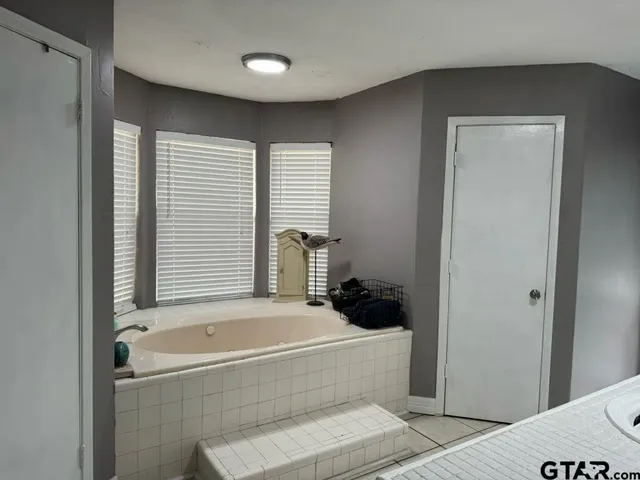a bathroom with a sink vanity and a mirror