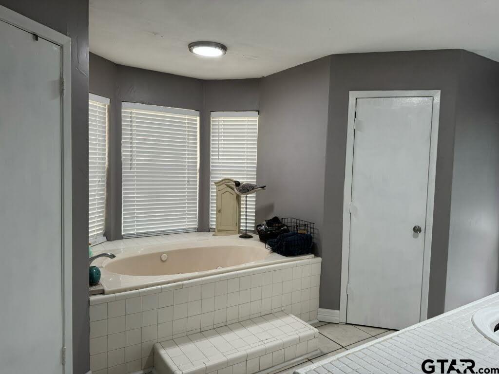 14032 Eastside Road Tyler, TX 75707 - Photo 24 of 36 a bathroom with a tub and a shower