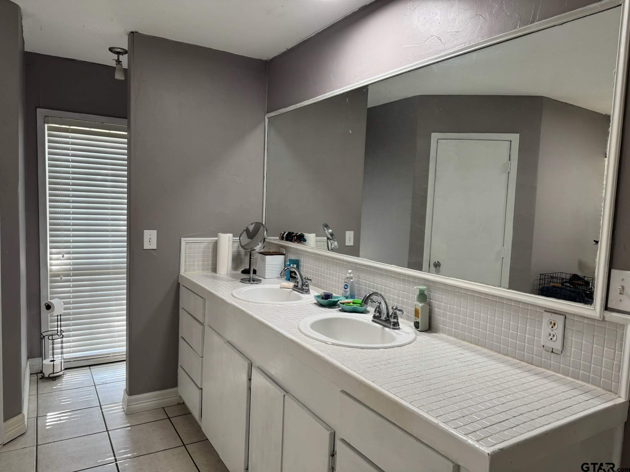 14032 Eastside Road Tyler, TX 75707 - Photo 25 of 36 a bathroom with a sink vanity and a mirror