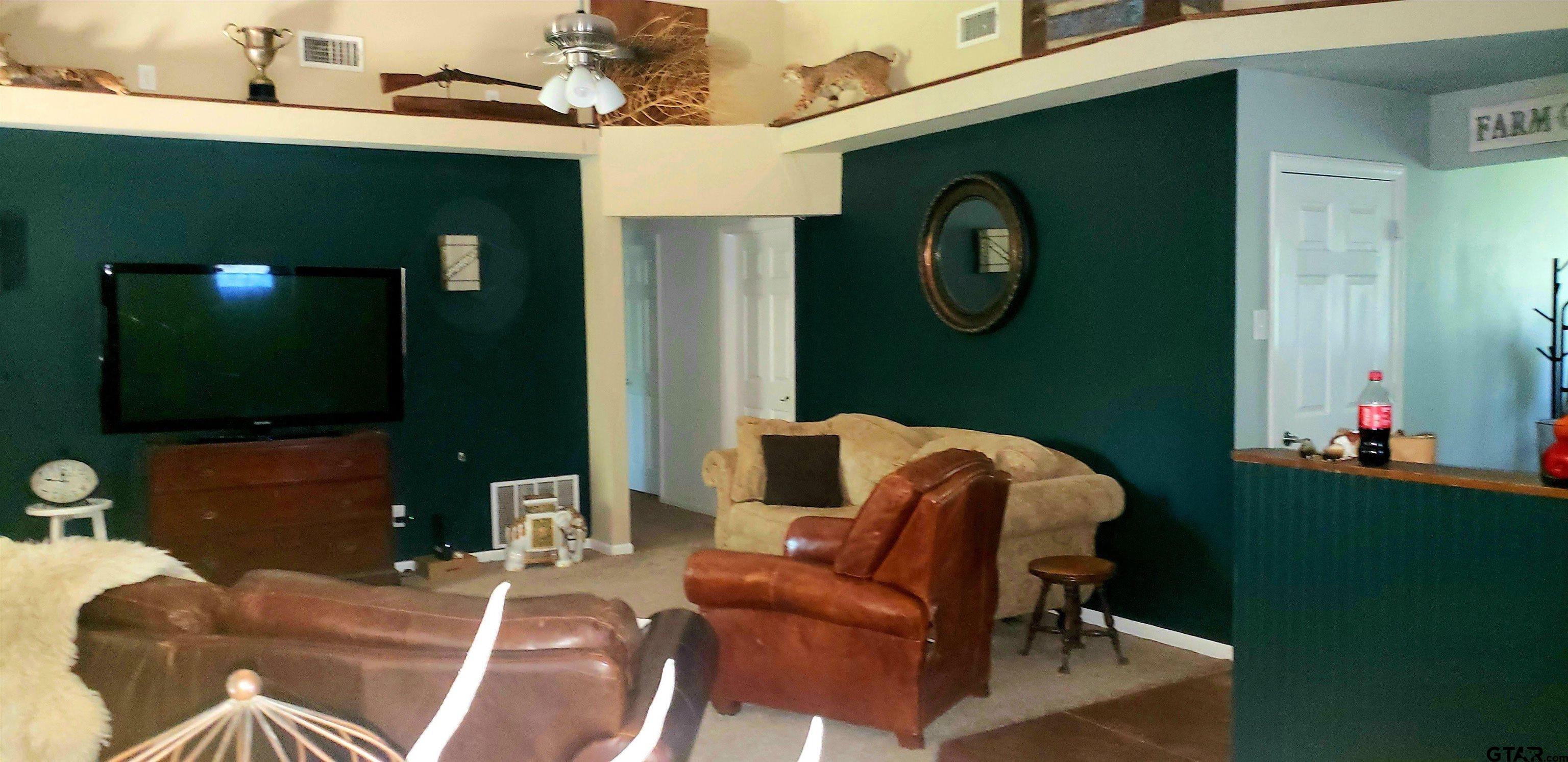 14032 Eastside Road Tyler, TX 75707 - Photo 32 of 36 a living room with furniture and a mirror