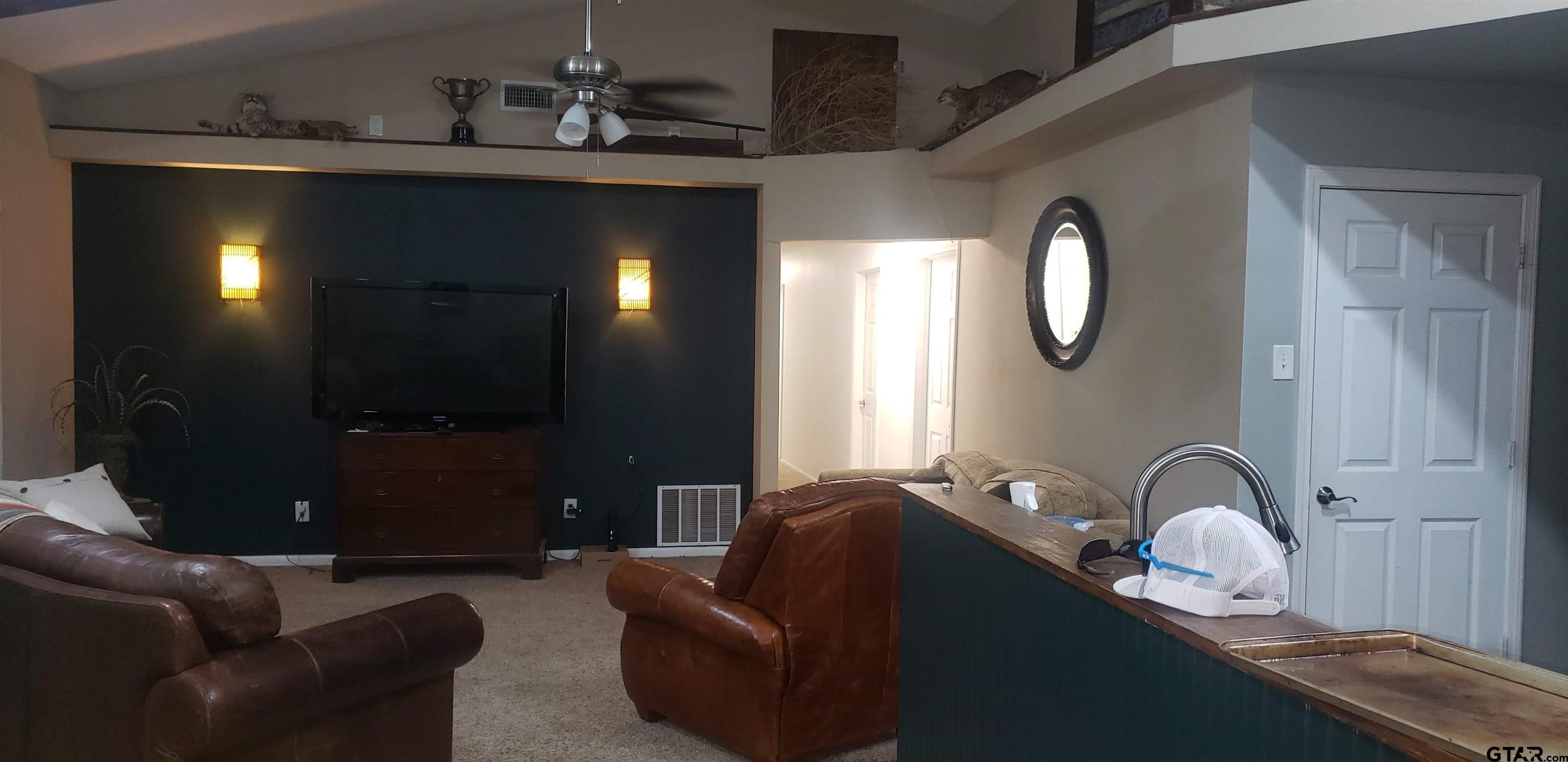 14032 Eastside Road Tyler, TX 75707 - Photo 33 of 36 a living room with furniture and a chandelier
