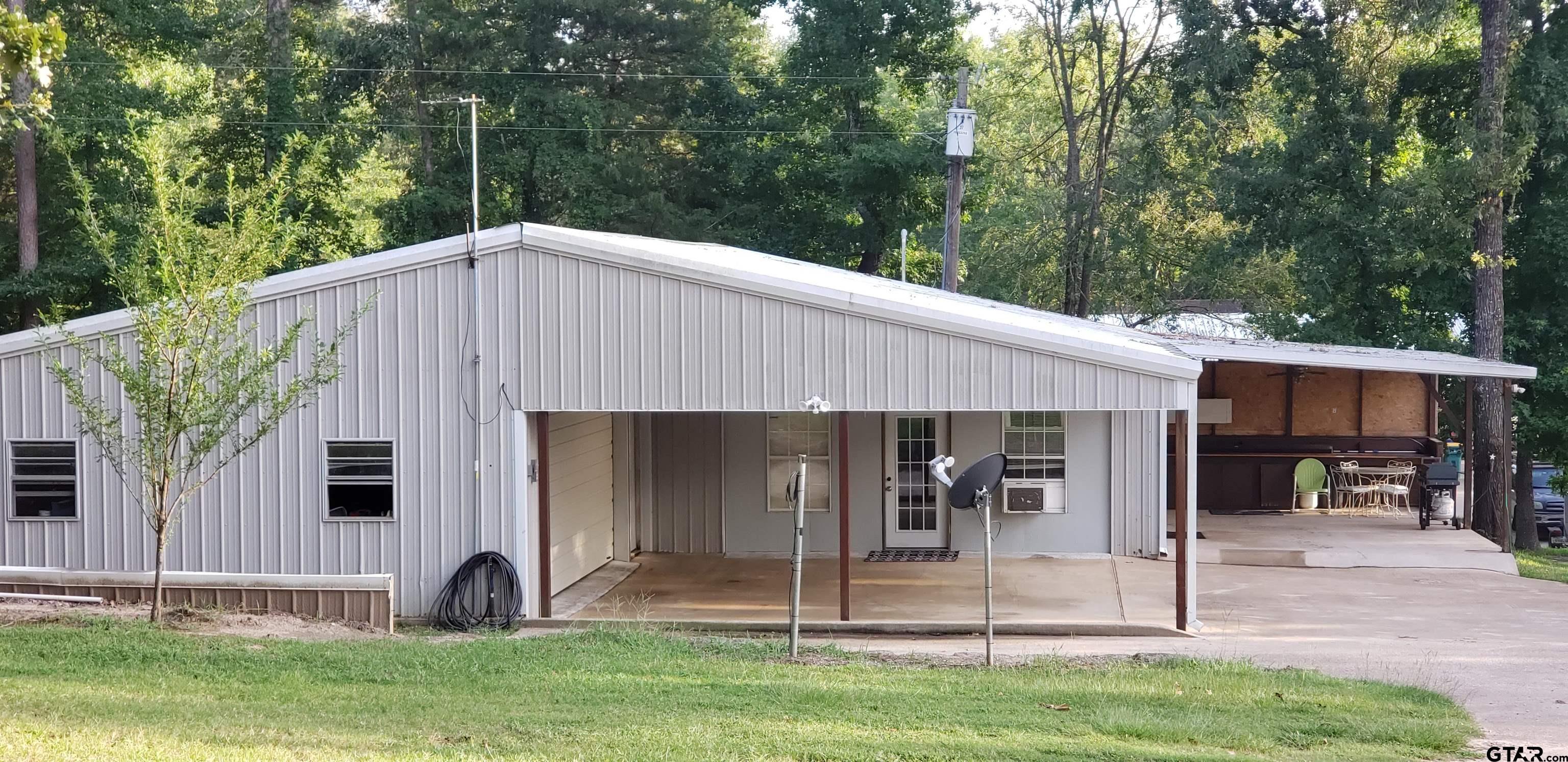 14032 Eastside Road Tyler, TX 75707 - Photo 34 of 36 a view of a house with backyard and porch