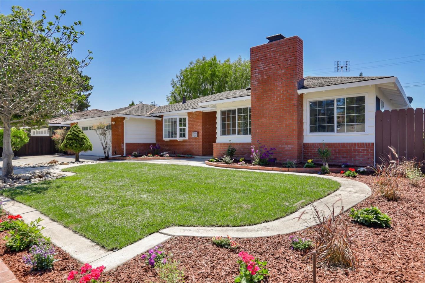 a view of a house with backyard sitting area and garden