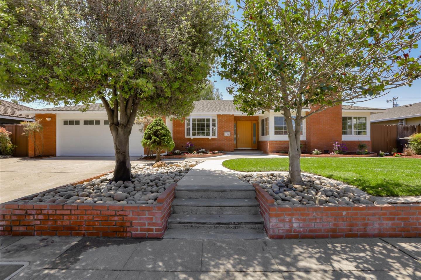 1241 Wasatch Drive Mountain View, CA 94040 - Photo 3 of 66 a front view of a house with a garden and trees