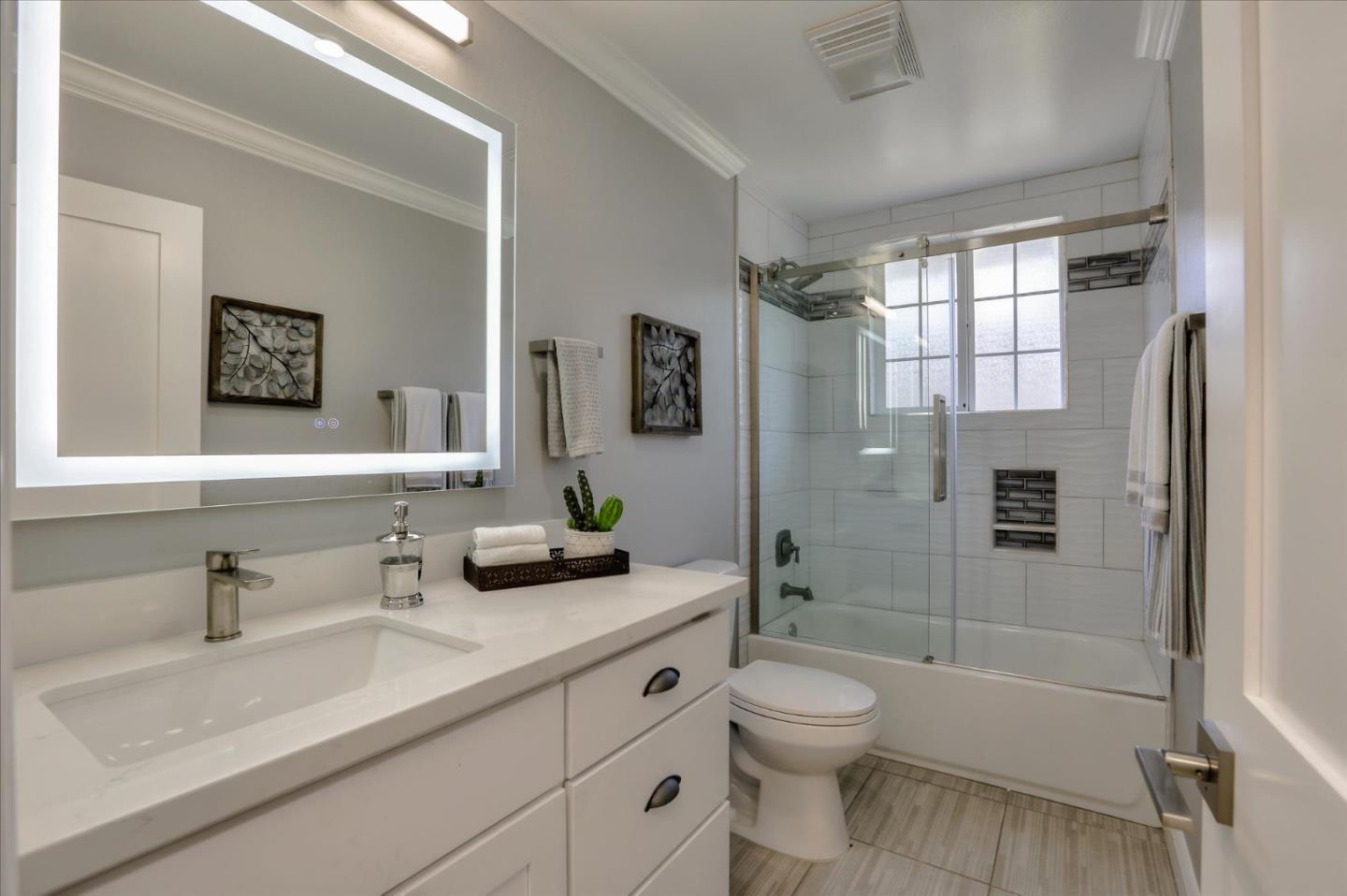 1241 Wasatch Drive Mountain View, CA 94040 - Photo 51 of 66 a bathroom with a double vanity sink toilet and shower
