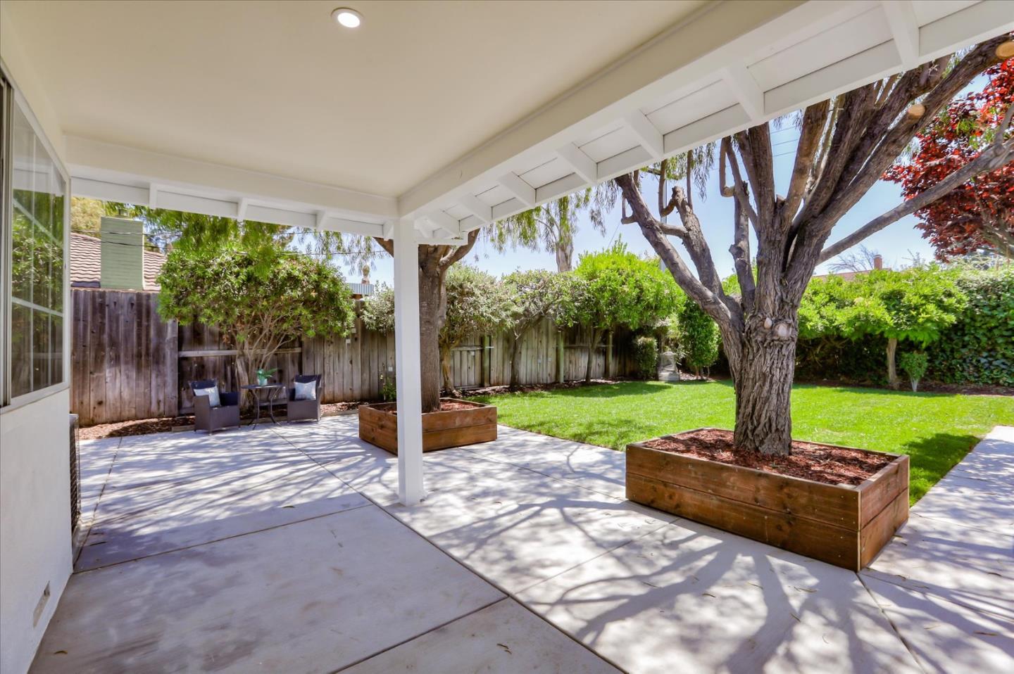 1241 Wasatch Drive Mountain View, CA 94040 - Photo 53 of 66 a view of a patio with a table chairs and a yard