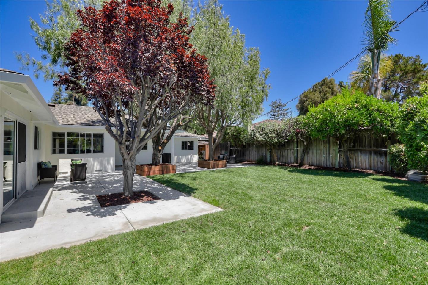 1241 Wasatch Drive Mountain View, CA 94040 - Photo 60 of 66 a front view of a house with a garden and trees