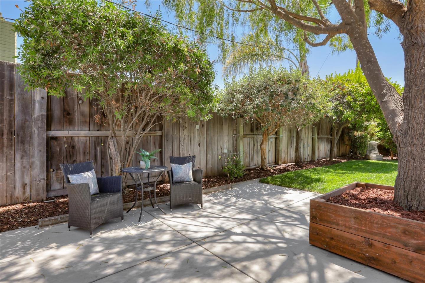 1241 Wasatch Drive Mountain View, CA 94040 - Photo 62 of 66 a view of a backyard with table and chairs potted plants and a large tree