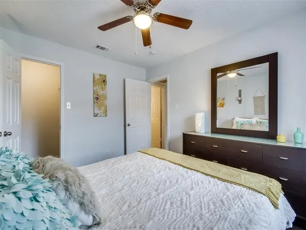 a bedroom with a bed and a painting on the wall
