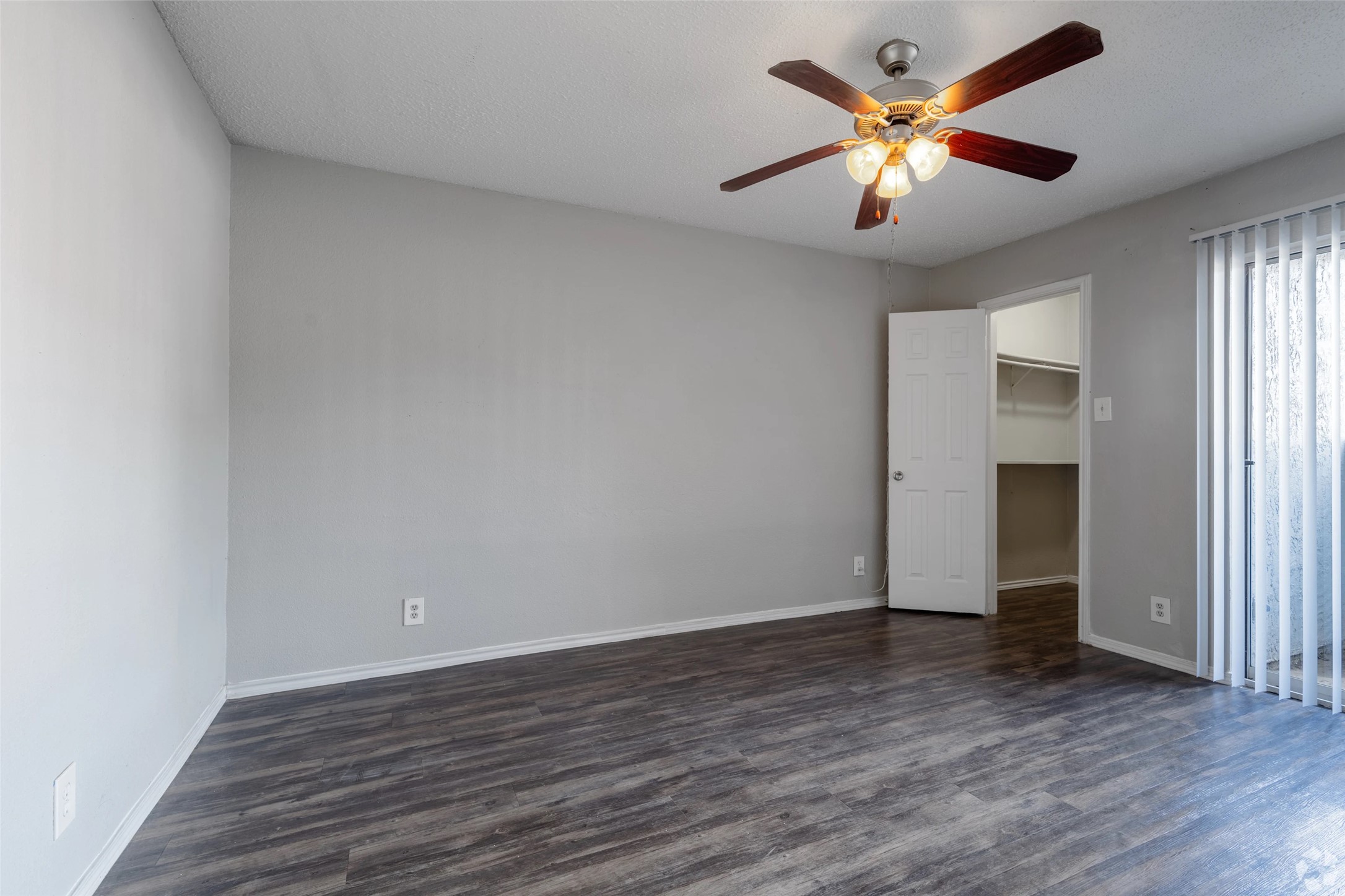 7610 Cameron Road, Unit 379 Austin, TX 78752 - Photo 2 of 42 an empty room with wooden floor and a ceiling fan