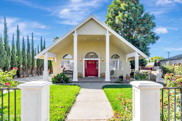 a front view of a house with garden